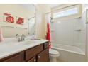 Bathroom with a single vanity, framed mirror, and a shower-tub combination with a bright shower curtain at 106 Cypress Creek Dr., Murrells Inlet, SC 29576