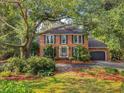 Charming two-story brick home with a well-maintained lawn and an attached two-car garage at 1073 Crooked Oak Dr., Pawleys Island, SC 29585
