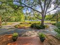 Inviting front porch with potted plants and a view of the landscaped yard and driveway at 1073 Crooked Oak Dr., Pawleys Island, SC 29585