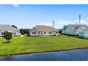 Expansive backyard with lush lawn extending to the waterfront, providing a serene outdoor space at 1149 6Th Ave. S, North Myrtle Beach, SC 29582