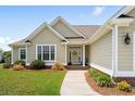 Welcoming home entrance with meticulously landscaped garden and a view of front door with glass at 1149 6Th Ave. S, North Myrtle Beach, SC 29582