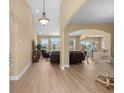 Bright living room with open floor plan, archways, light hardwood floors and elegant furnishings at 1149 6Th Ave. S, North Myrtle Beach, SC 29582