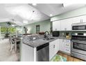 Modern kitchen features granite countertops, stainless steel appliances, and white cabinetry at 117 Pinehurst Ln. # 5-J, Pawleys Island, SC 29585