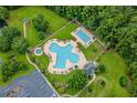 Aerial view of a luxurious pool area with ample seating, landscaping, hot tub and a kiddie pool at 117 Pinehurst Ln. # 5-J, Pawleys Island, SC 29585