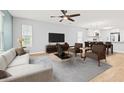 Living room features a ceiling fan, a gray couch, and transitions to the dining and kitchen area at 1208 River Oaks Dr. # 24-B, Myrtle Beach, SC 29579