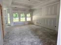 Spacious living room featuring large windows and tray ceiling at 1236 Mill Banks Dr., Longs, SC 29568