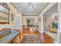 A spacious foyer offers hardwood floors, a view into other rooms, and a decorative rug at 1259 Oatland Lake Rd., Pawleys Island, SC 29585