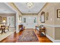 Elegant foyer features hardwood floors, chandelier, a colorful rug, and lots of natural light at 1259 Oatland Lake Rd., Pawleys Island, SC 29585
