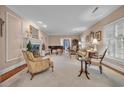A bright living room featuring stylish furnishings, a fireplace, and large windows for natural light at 1259 Oatland Lake Rd., Pawleys Island, SC 29585