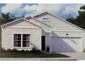 Charming single-story home featuring a two-car garage, lush green lawn and inviting, covered entryway at 154 Waterloo Sunset Dr., Longs, SC 29568