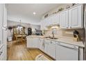 Bright kitchen with white cabinets, modern appliances, and a view to dining area at 141 Lazy Willow Ln. # 103, Myrtle Beach, SC 29577
