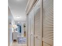 Neutral hallway with hardwood floors, flush mount lighting, storage closet, and white painted trim at 1615 S Ocean Blvd. # 4, Surfside Beach, SC 29575