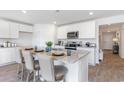 Open kitchen showcasing a granite island with bar stool seating, stainless appliances and white cabinetry at 169 Dagger Ct., Myrtle Beach, SC 29588