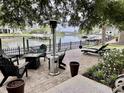 Serene backyard patio features comfortable seating, a modern heat lamp, and a water view at 17 Carson Creek Dr., Murrells Inlet, SC 29576