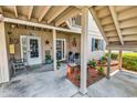 Charming ground-level entryway featuring dual entrances, seating, and well-maintained landscaping at 1870 Auburn Dr. # 22A, Surfside Beach, SC 29575