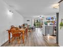 Open-concept living area with wood-look floors, slider to deck, and bar seating at 1870 Auburn Dr. # 22A, Surfside Beach, SC 29575