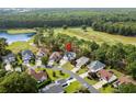 An aerial view of a home located in a neighborhood next to a golf course and lake at 2077 N Berwick Dr., Myrtle Beach, SC 29575