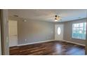 Spacious living room with ample natural light, ceiling fan, and wood-look floors at 2407 James St. # 401, Conway, SC 29527