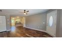 Open-concept living area with wood-look floors, neutral walls, and a ceiling fan at 2407 James St. # 401, Conway, SC 29527