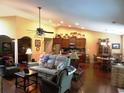 Open-concept living area featuring hardwood floors, neutral walls, and views of the kitchen and dining areas at 266 Tall Palms Way, Little River, SC 29566