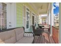 Inviting balcony features comfortable seating and views of the neighborhood at 305 Shuffleboard Ct., Myrtle Beach, SC 29572