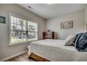 Cozy bedroom with natural light, wood floors, and neutral wall color at 316 Lifestyle Court, Surfside Beach, SC 29575