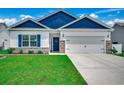 Charming single-story home with blue accents, manicured lawn and two car garage at 316 Lifestyle Court, Surfside Beach, SC 29575