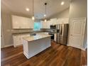 Modern kitchen features white cabinets, granite countertops, stainless steel appliances, and an island at 3204 Fowler School Rd., Loris, SC 29569