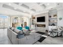 Open living room showcasing coffered ceilings, a stone fireplace, and stylish decor, perfect for entertaining at 400 Summerwood Ct., Myrtle Beach, SC 29579
