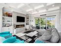 Bright living room with a modern fireplace, a coffered ceiling, and sliding doors leading to the outdoor space at 400 Summerwood Ct., Myrtle Beach, SC 29579