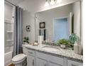 Stylishly decorated bathroom features granite vanity, framed mirror, toilet, and shower with blue curtain at 420 Meadow Sweet Pl, Conway, SC 29526