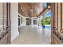 Beautiful tiled patio with a wood ceiling, ceiling fan, recessed lighting, arched openings, and access to the pool at 434 Posada Dr., Myrtle Beach, SC 29572