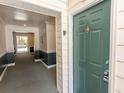 Condo front entrance with a green door and an inviting hallway view at 4370 Crepe Myrtle Ct. # F, Murrells Inlet, SC 29576