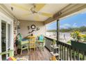 Cozy condo balcony with colorful seating, river views, and tropical decor, creating a vibrant outdoor retreat at 4445 Kingsport Rd. # 101, Little River, SC 29566
