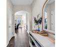 Elegant foyer with hardwood floors, arched doorway, and decorative mirror at 447 Honeyhill Loop, Conway, SC 29526