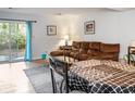 Comfortable living room with a brown sectional, dining table, and sliding glass doors at 4505 N Kings Hwy. # E2, Myrtle Beach, SC 29577