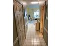 Inviting hallway with light-colored tile flooring, leading to a living area with natural light at 4753 Wild Iris Dr. # 301, Myrtle Beach, SC 29577