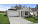 Charming single-story home with a gray exterior, well-manicured lawn, and a two-car garage at 4846 Hopespring St., Myrtle Beach, SC 29579
