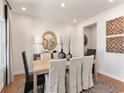 Elegant dining room featuring stylish decor, a round mirror, and a natural wood table at 4877 Hopespring St., Myrtle Beach, SC 29579