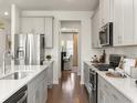 Modern kitchen features stainless steel appliances, grey cabinets, and an open design at 4877 Hopespring St., Myrtle Beach, SC 29579