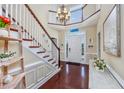 Grand foyer with hardwood floors, staircase, chandelier, and plenty of natural light at 504 Sea Vista Ln., North Myrtle Beach, SC 29582