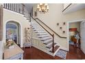 Elegant foyer featuring dark wood floors, white wainscoting, and a staircase with natural light at 504 Sea Vista Ln., North Myrtle Beach, SC 29582