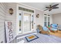 Inviting front porch with cozy seating, stylish lighting, and a decorative 'Beach' sign at 504 Sea Vista Ln., North Myrtle Beach, SC 29582