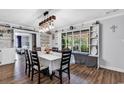 Bright dining room featuring hardwood floors, modern light fixture, and decorative window bench at 5114 Cowart Ct., Murrells Inlet, SC 29576