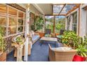 Comfortable sunroom with wicker furniture, lots of potted plants, and a translucent ceiling for natural light at 5114 Cowart Ct., Murrells Inlet, SC 29576