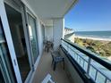 Enjoy ocean views from the spacious balcony with comfortable seating at 601 Retreat Beach Circle # 521, Pawleys Island, SC 29585