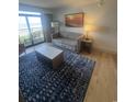Bright living room featuring a modern sofa, stylish rug, and a balcony with ocean views at 7100 North Ocean Blvd. # 617, Myrtle Beach, SC 29577
