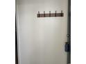 A coat rack is mounted on the wall in the entryway at 770 Charter Dr. # C4, Longs, SC 29568