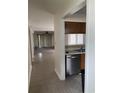 Open kitchen view with stainless steel dishwasher and pass-through to the spacious living area at 770 Charter Dr. # C4, Longs, SC 29568