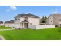 Charming exterior showcasing a two-story design, a two-car garage, and a well-maintained lawn at 79 S Reindeer Rd., Surfside Beach, SC 29575